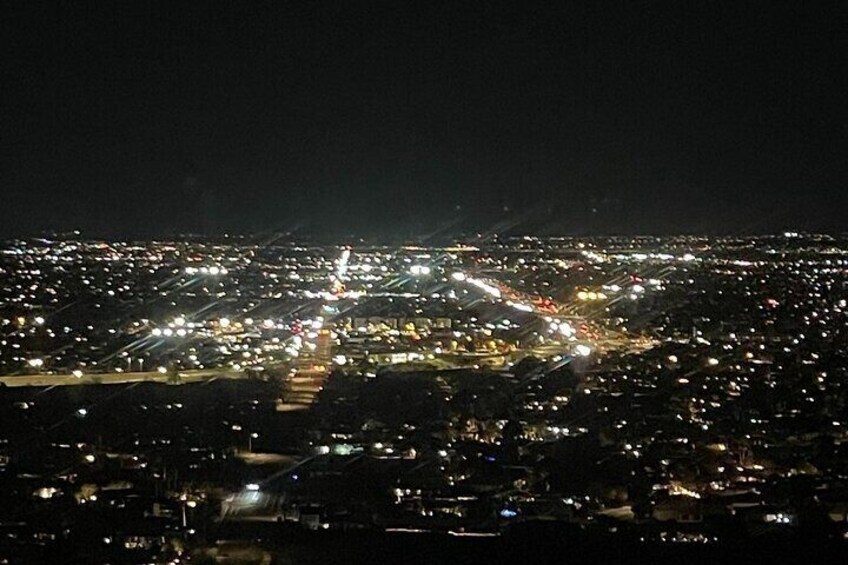 A nighttime cityscape with illuminated streets and buildings. 1