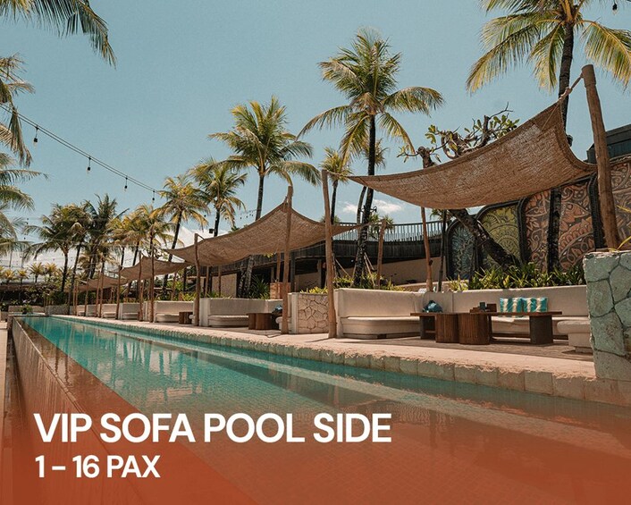 A poolside area with VIP sofas and palm trees. 2