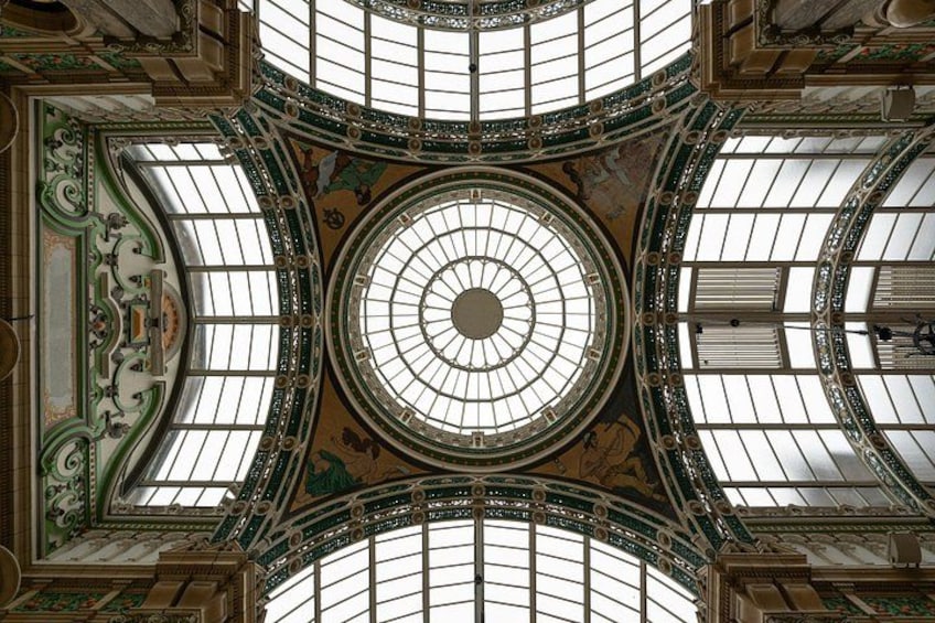 A grand architectural interior with a central dome, ornate ceiling, and intricate designs. 4