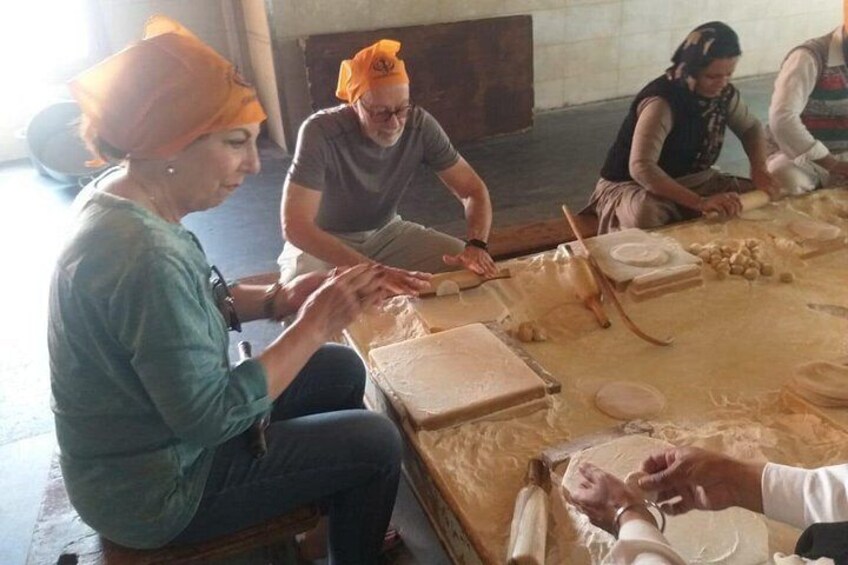 People engaged in pottery making, with clay and pottery wheels visible. 1