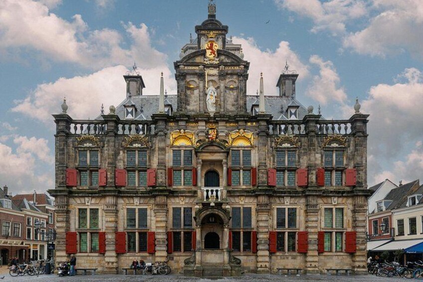 A historic building with ornate architecture, a central entrance, and a clock tower. 3