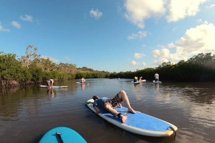 A calm river with people on paddleboards. 2