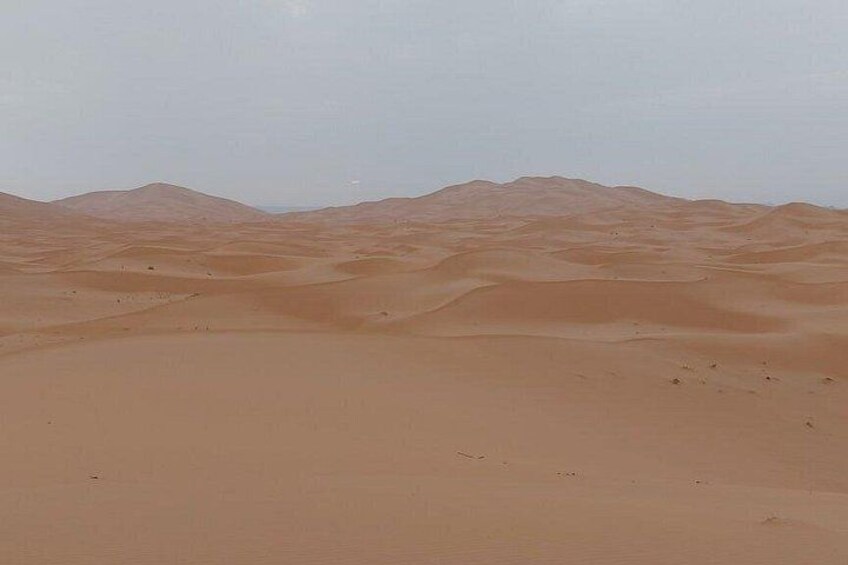 A desert landscape with sand dunes and a clear sky. 2
