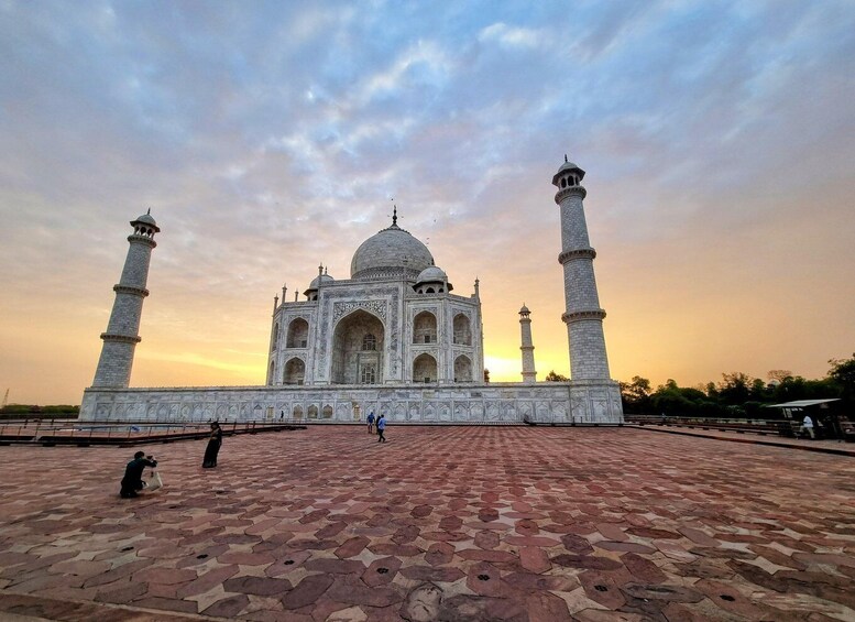 The Taj Mahal with a clear sky and a paved foreground. 5