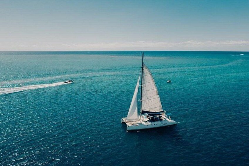 A sailboat on a calm sea with a clear sky. 2