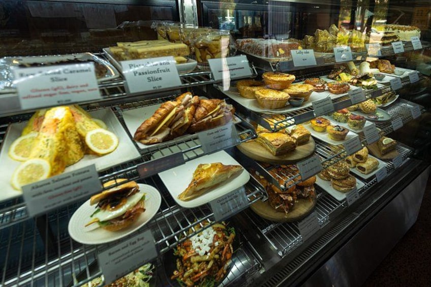 A bakery display case with various pastries and desserts. 5