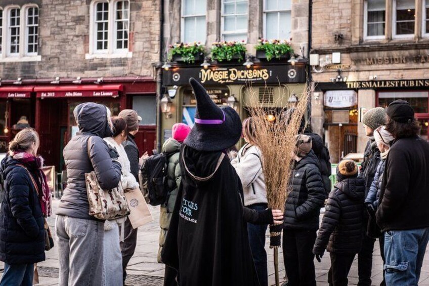 A crowd of people in a street with shops, including one named 'Dessie Dicksons'. 5