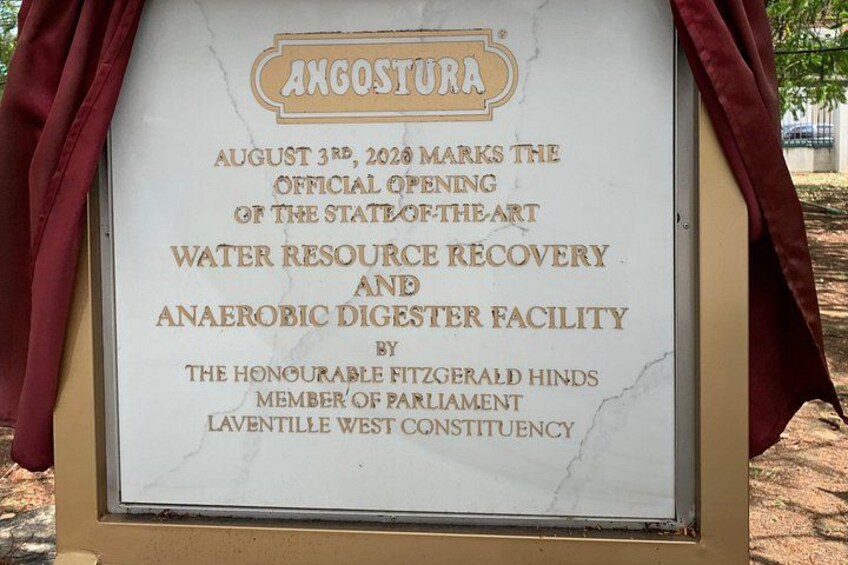 A sign with the name 'Angostura' and details about an official opening event. 3