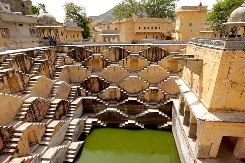 A historical water management system with a central water body and surrounding stone structures. 2
