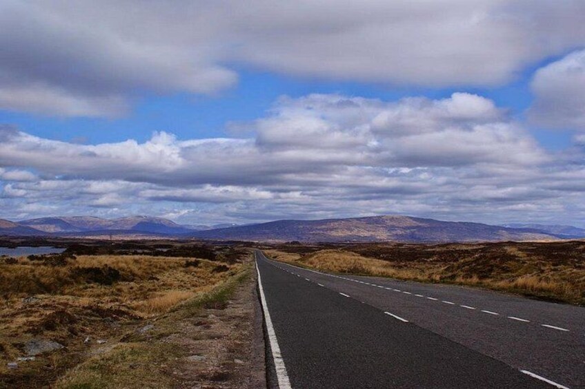 A road with a clear sky and distant mountains. 2