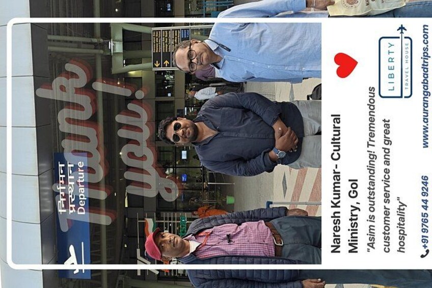 A travel advertisement with a man in a blue shirt, another in a checkered shirt, and a third in a pink shirt. 2