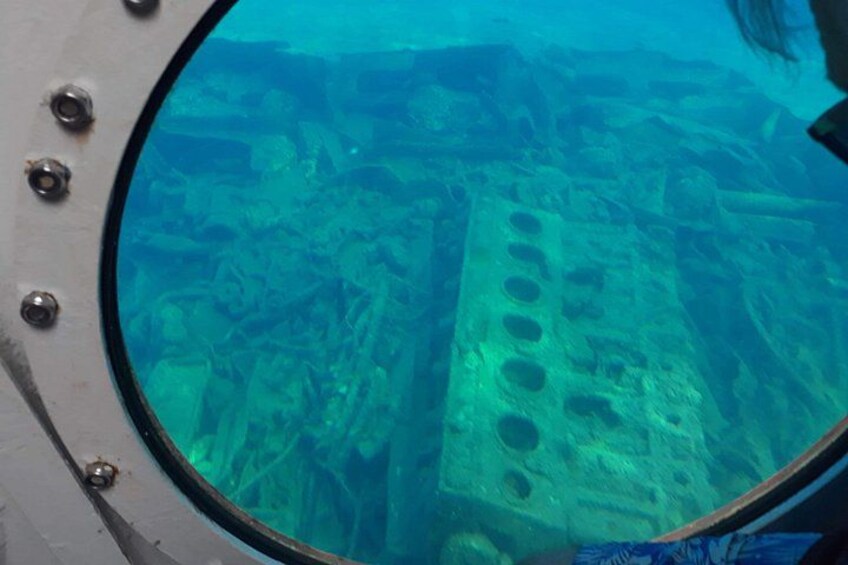 An underwater view of a shipwreck with visible structural details and holes. 2