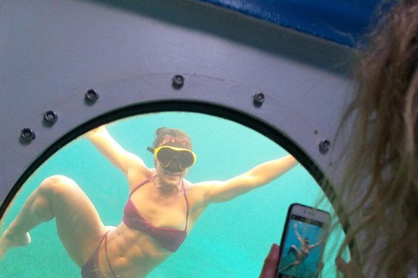 A person in a swimsuit and snorkel gear swimming underwater. 3