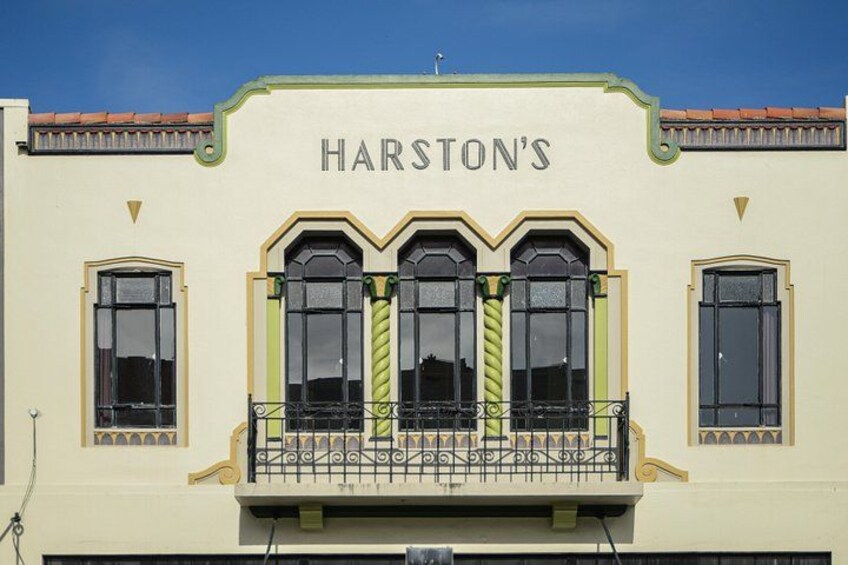 A building with the sign 'HARSTON'S' above three arched windows. 2