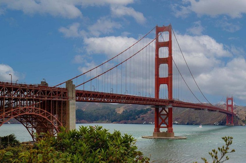 The Golden Gate Bridge with its distinctive towers and suspension cables, surrounded by water and greenery. 4