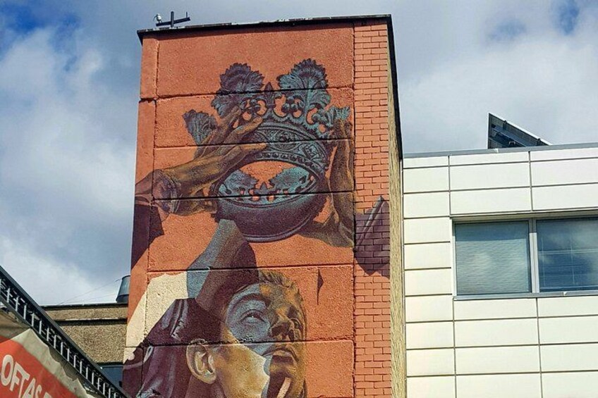 A mural on a building with a large, ornate design. 4