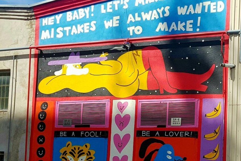 A colorful mural with a yellow elephant, a tiger, and a banana. 2