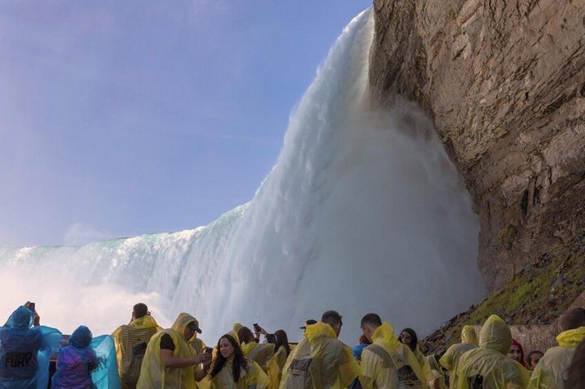 A large waterfall with people observing it. 3