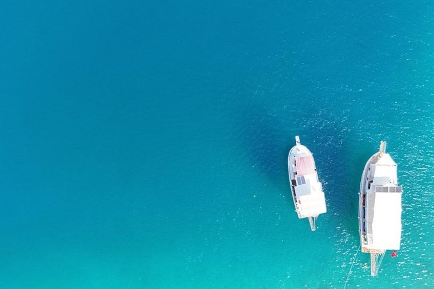Two white boats on turquoise water. 4