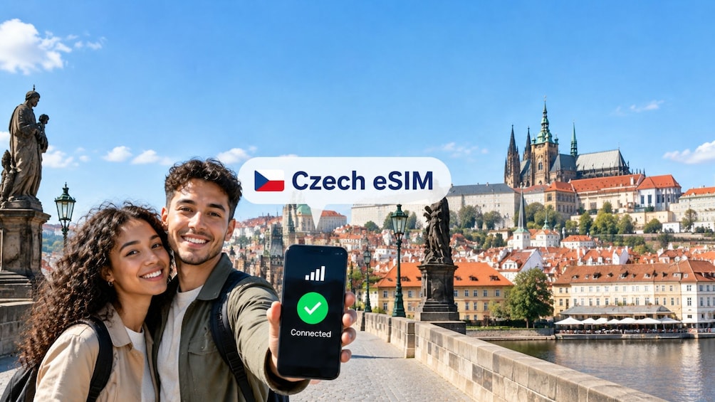 A couple taking a selfie with a smartphone displaying a Czech eSIM logo, with historic architecture and a river in the background. 1