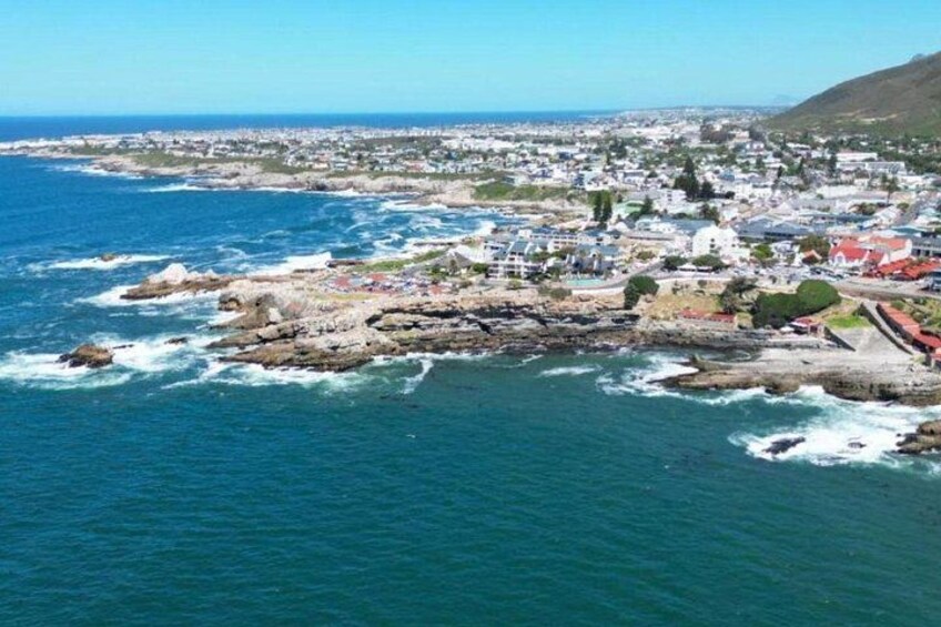 A coastal town with rocky outcrops, a harbor, and buildings along the shoreline. 3