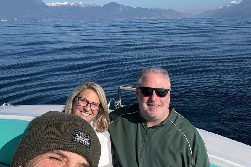 A boat on a body of water with mountains in the background. 2