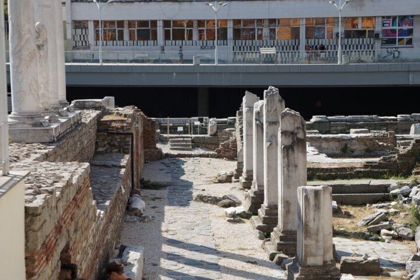 Ancient ruins with columns and stone structures. 4