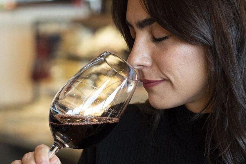 A person holding a wine glass. 1