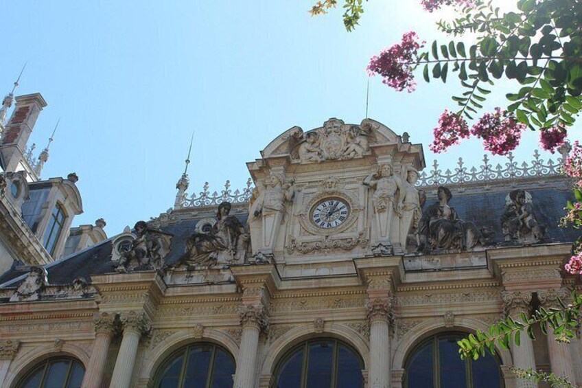 Ein historisches Gebäude mit aufwendigen Skulpturen und einer Uhr. 4