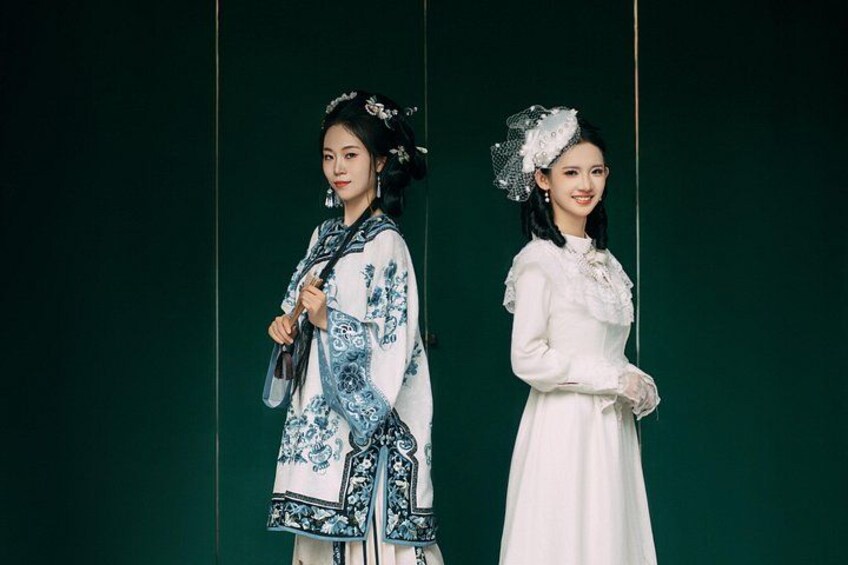 Two individuals in traditional attire against a green background. 3