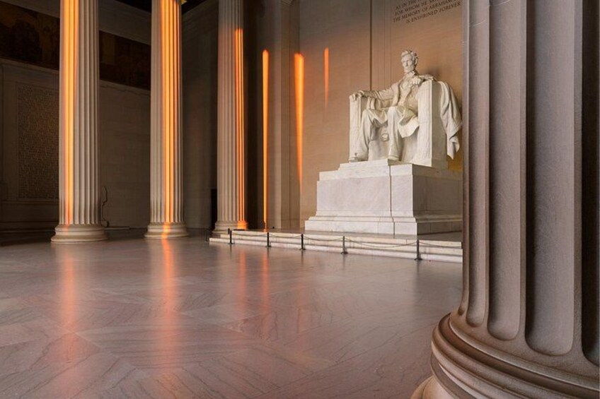 A marble statue in a room with tall columns and a polished floor. 3