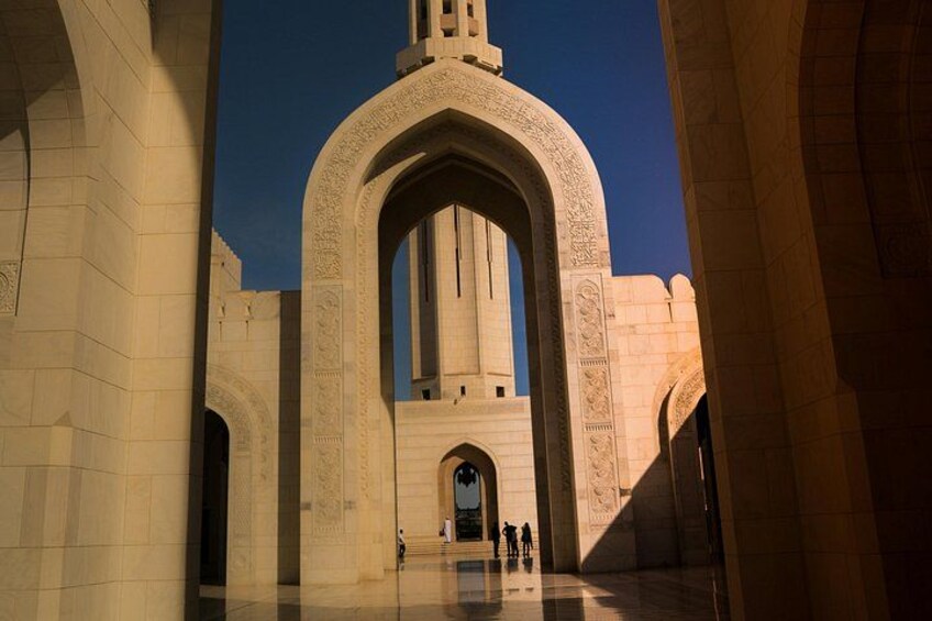 An architectural structure with arched doorways and a central tower. 1