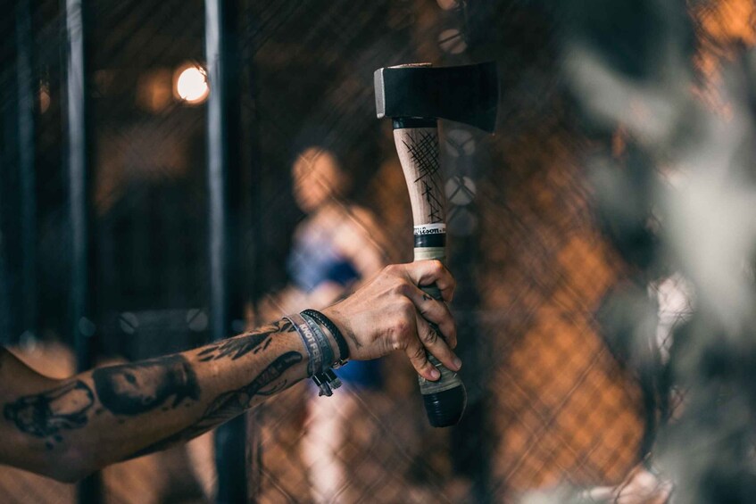 A person holding a hammer with a wooden handle and a metal head. 3