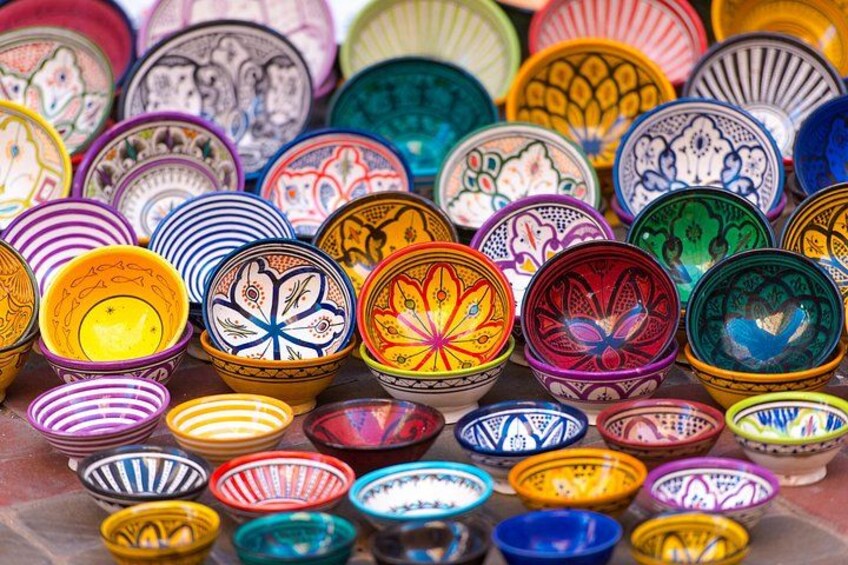A vibrant collection of handcrafted Moroccan pottery bowls, showcasing intricate designs and rich colors, a testament to the country’s renowned artisanal heritage found in local markets. 4