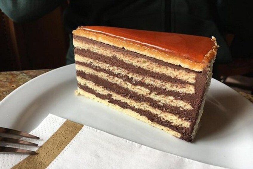 A slice of layered cake on a white plate with a napkin underneath. 2