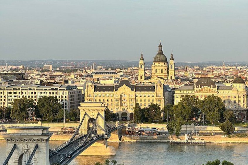 A cityscape with a prominent bridge, a large cathedral, and a river. 4