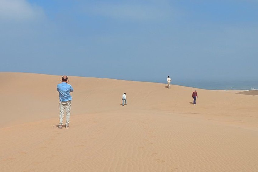 A desert landscape with sand dunes and a clear sky. 3