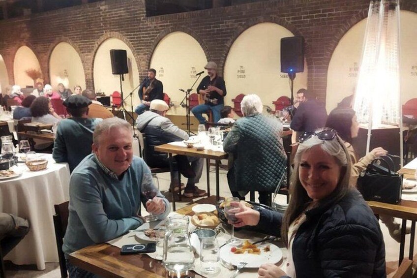 A group of people dining in a restaurant with brick walls and arched ceilings. 3