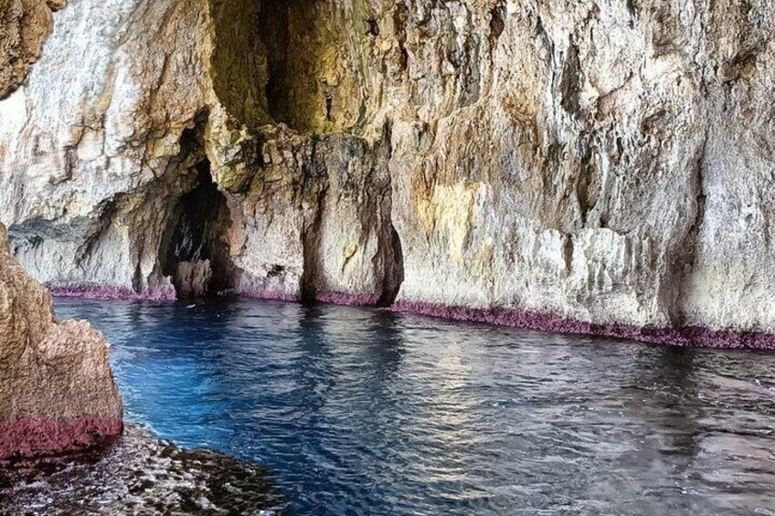 A cave with water at the bottom and a rocky wall. 2