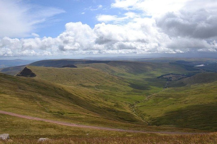 Rolling hills, a winding road, and a valley. 2