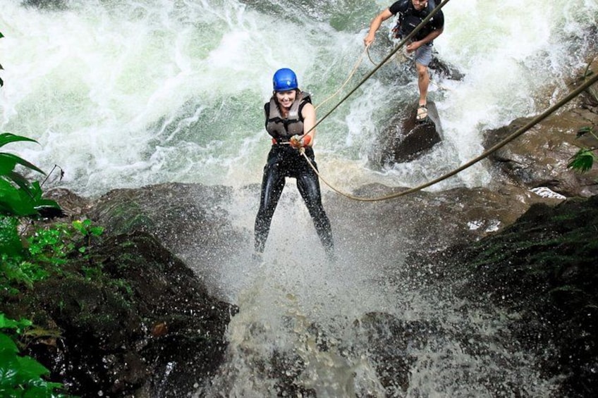 A person rappelling down a waterfall. 2