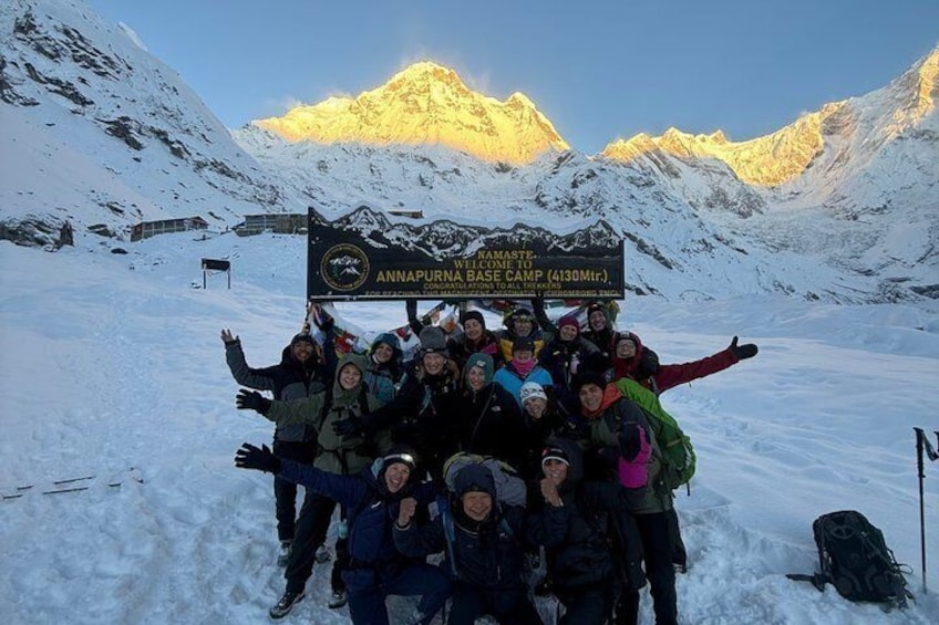 A group of people at the base camp of Annapurna, with snow-covered mountains in the background. 1