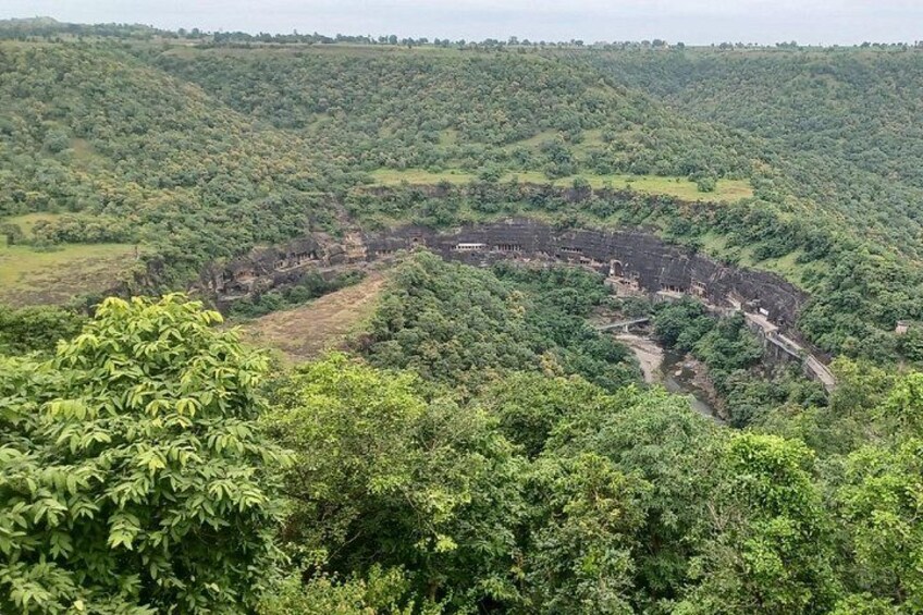 A large, ancient amphitheater surrounded by dense forest. 1