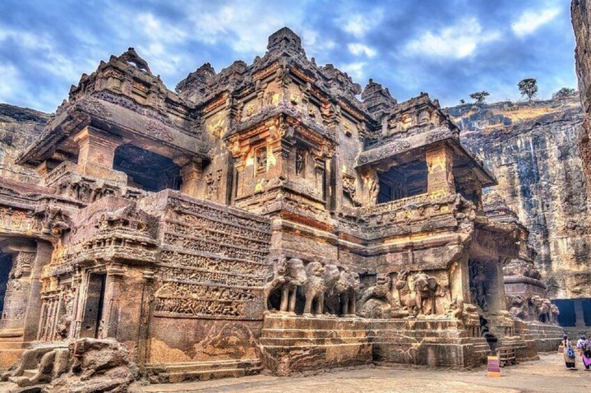 An ancient temple with intricate carvings and a large stone structure. 2