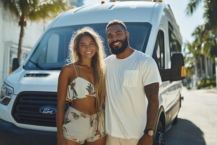 A couple standing in front of a white van with palm trees in the background. 3