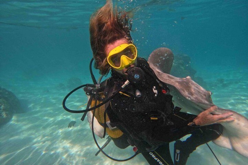 A person scuba diving underwater with a yellow snorkel and fins. 2