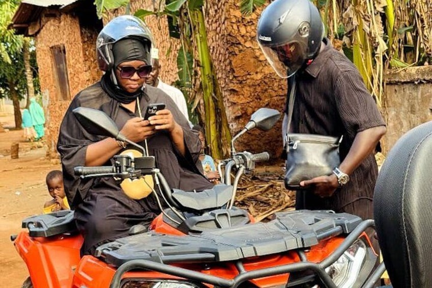 Two people on a motorcycle, one holding a phone, and another with a bag. 5
