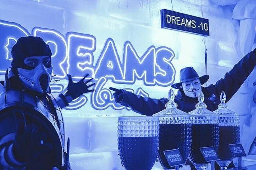 A person in a gas mask and hat playing a drum set with a neon sign in the background. 4
