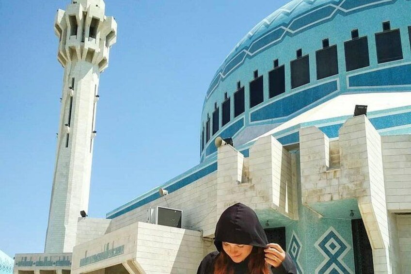 A mosque with a tall minaret and a dome with geometric patterns. 4