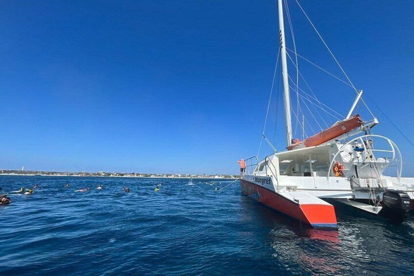 A sailboat named 'Margaret' on calm waters with a clear sky. 3